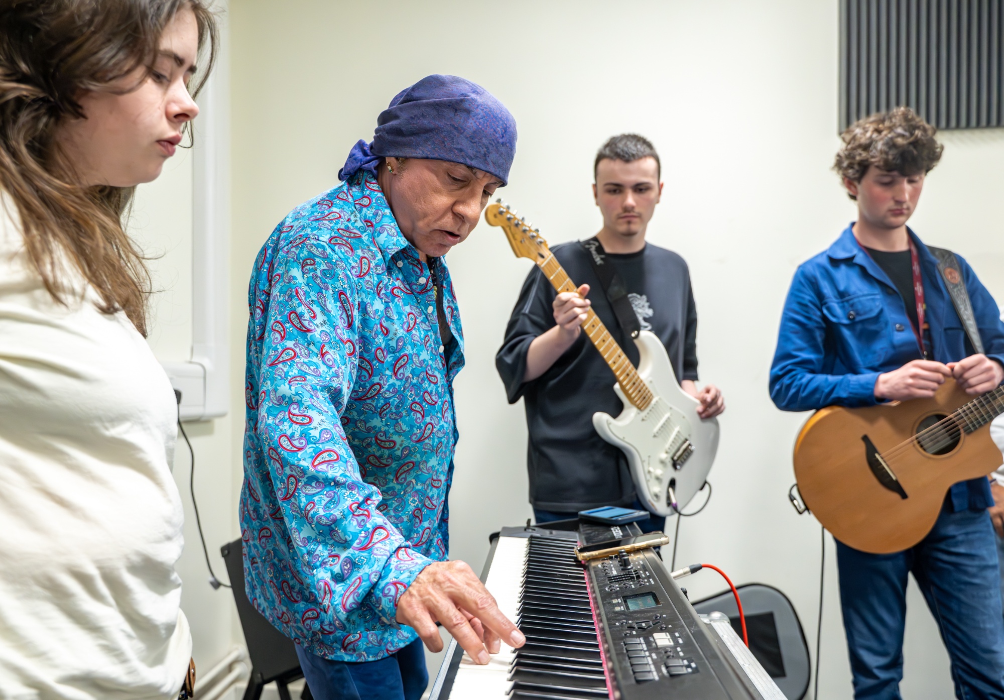 Steve joins three students rehearsing in the practice rooms for their task. 