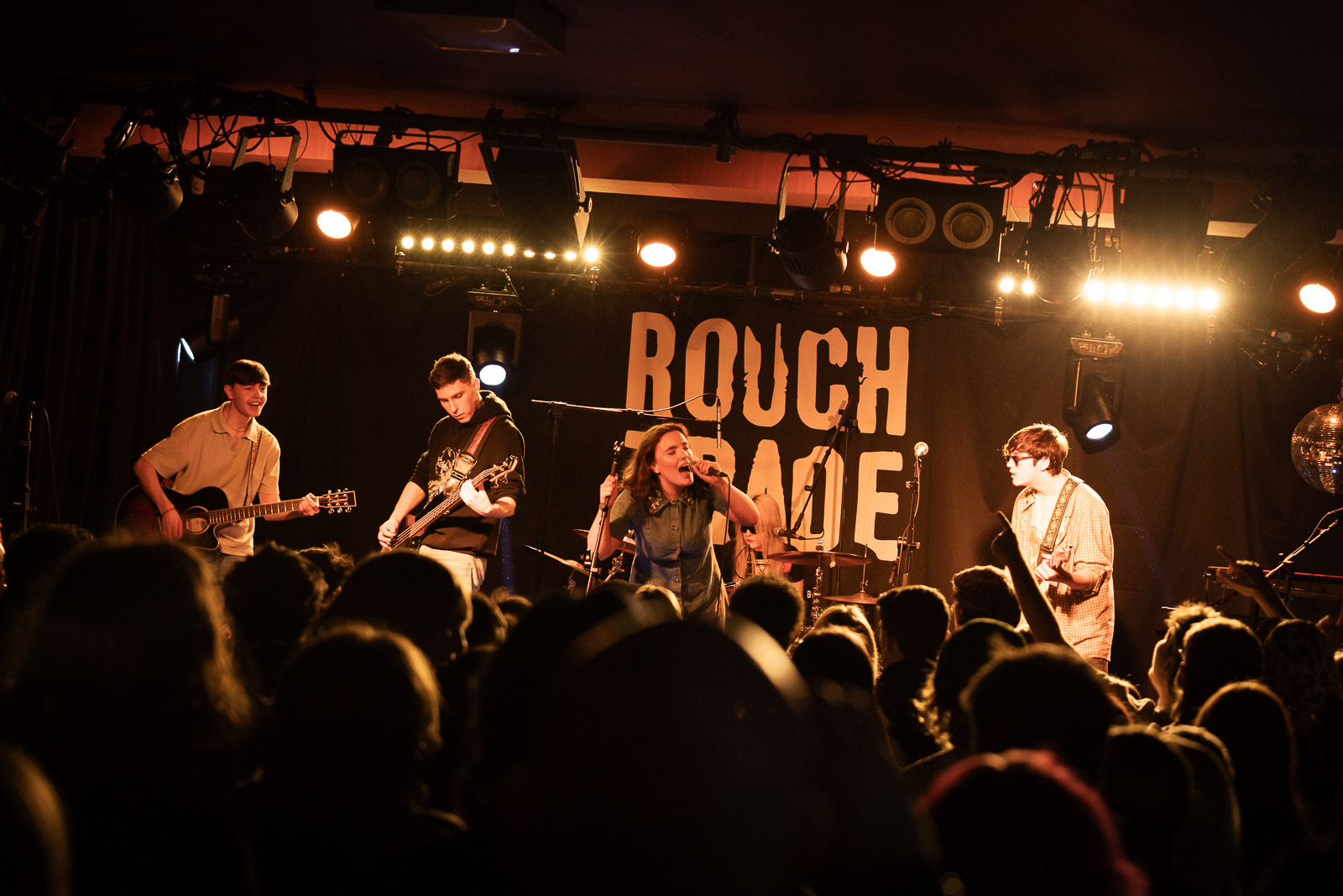 A band performing on stage with passion,