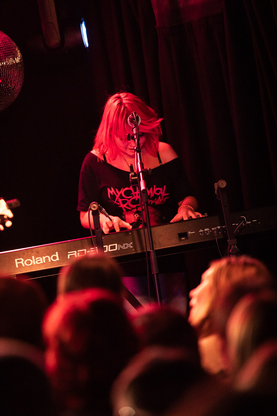 Keyboard player performing on stage.