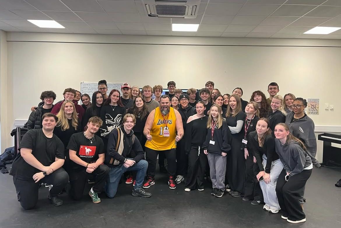 Group of students with professional at the end of a masterclass.