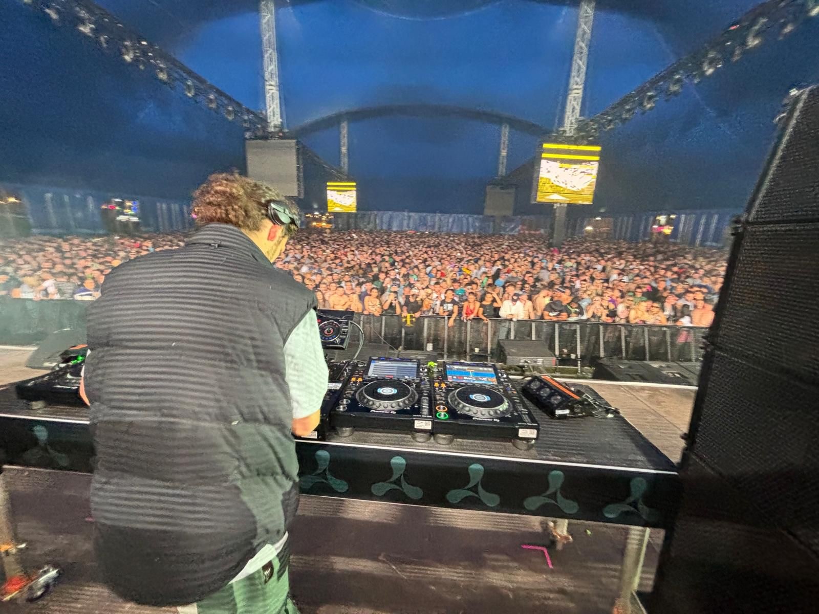 Student DJing on stage at Creamfields in a packed out stage. 