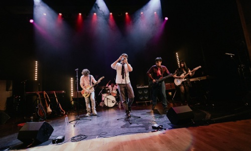 A band of students performing on stage.